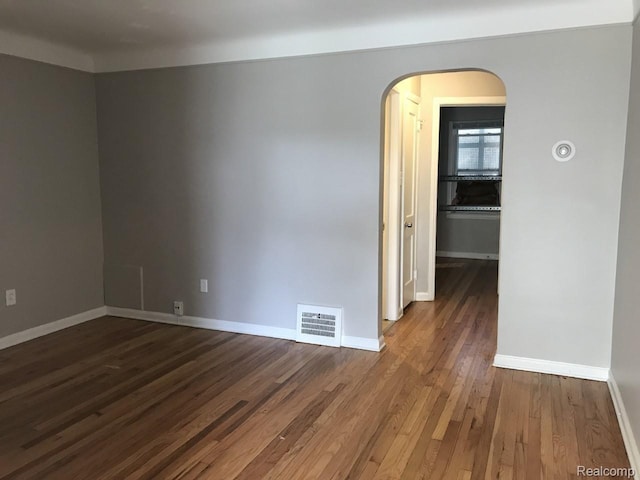 19381 Kenosha St, Harper Woods, MI 48225 - spare room featuring wood finished floors, baseboards, and arched walkways