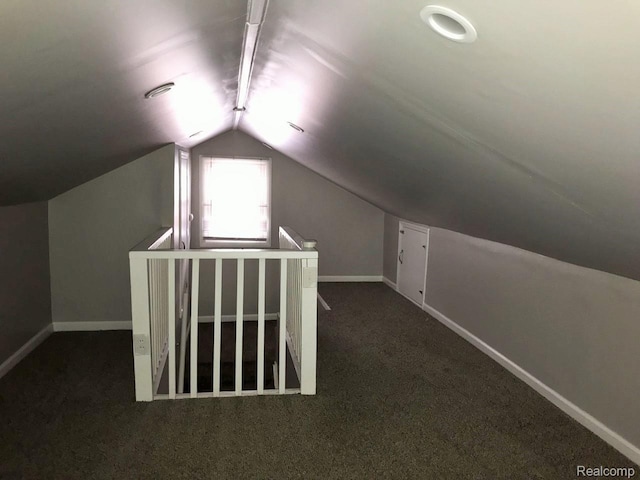 19381 Kenosha St, Harper Woods, MI 48225 - bonus room with dark colored carpet, lofted ceiling, and baseboards