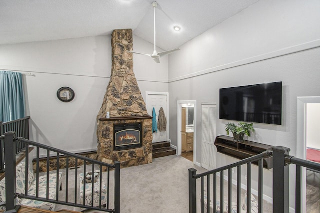 1912 E Centre Ave, Portage, MI 49002 - carpeted living area featuring a stone fireplace and high vaulted ceiling