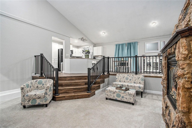 1912 E Centre Ave, Portage, MI 49002 - sitting room featuring lofted ceiling, carpet flooring, baseboards, a fireplace, and stairs