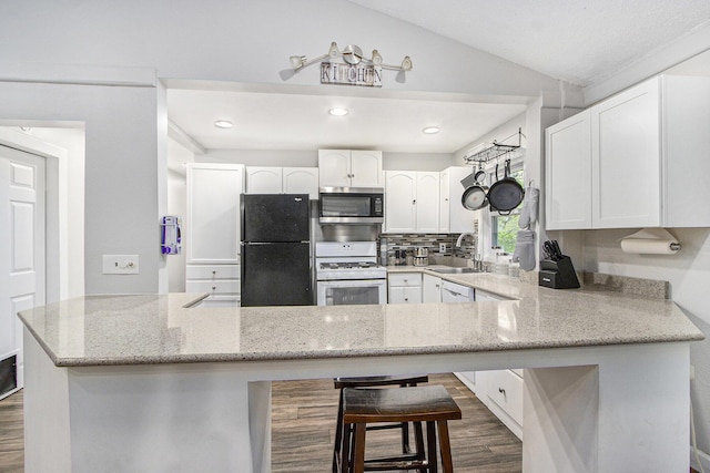 1912 E Centre Ave, Portage, MI 49002 - kitchen with white appliances, a sink, dark wood-style flooring, white cabinets, and lofted ceiling