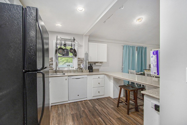 1912 E Centre Ave, Portage, MI 49002 - kitchen featuring freestanding refrigerator, dishwasher, a sink, white cabinetry, and light countertops