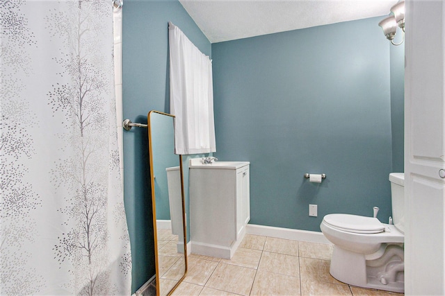 1912 E Centre Ave, Portage, MI 49002 - bathroom with toilet, tile patterned flooring, curtained shower, and baseboards