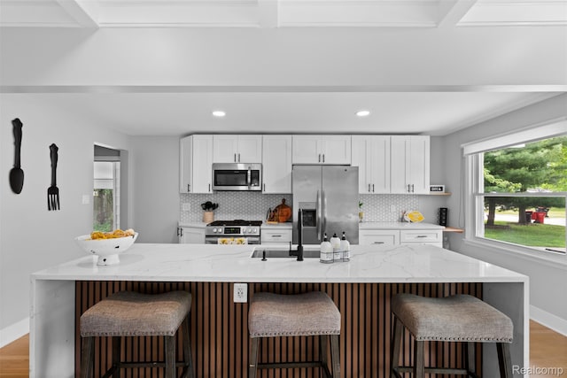 29748 Chelmsford Rd, Southfield, MI 48076 - kitchen with stainless steel appliances, tasteful backsplash, white cabinetry, wood finished floors, and recessed lighting