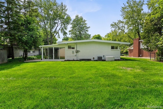 29748 Chelmsford Rd, Southfield, MI 48076 - back of property with central AC, a sunroom, and stucco siding
