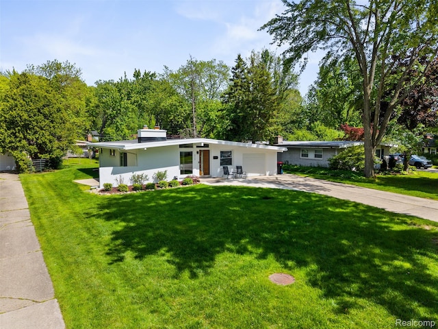 29748 Chelmsford Rd, Southfield, MI 48076 - mid-century home featuring driveway, an attached garage, a front lawn, and stucco siding