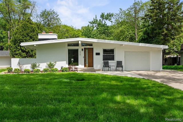 29748 Chelmsford Rd, Southfield, MI 48076 - mid-century home with a chimney, a garage, concrete driveway, a front lawn, and brick siding