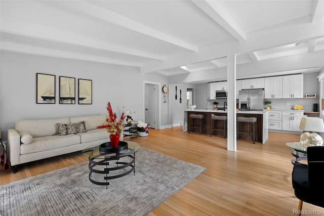 29748 Chelmsford Rd, Southfield, MI 48076 - living room with light wood-style floors, beamed ceiling, and baseboards
