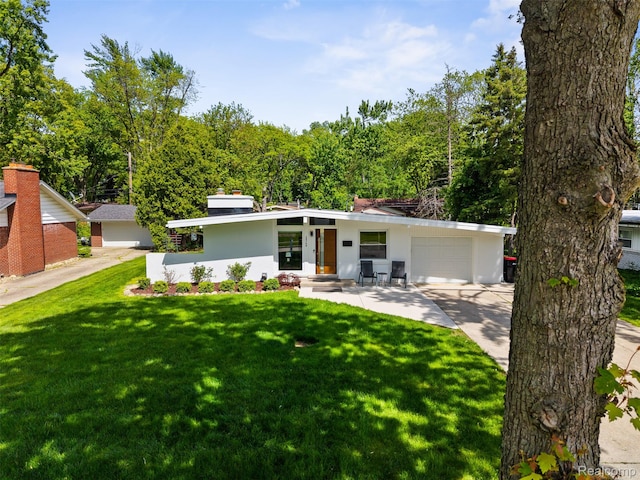 29748 Chelmsford Rd, Southfield, MI 48076 - mid-century inspired home featuring an attached garage, a front yard, concrete driveway, and stucco siding
