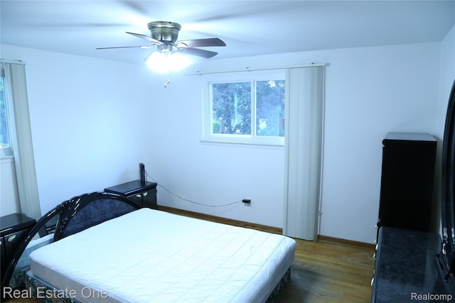 18675 Webster Ave, Southfield, MI 48076 - bedroom with wood finished floors, baseboards, and a ceiling fan