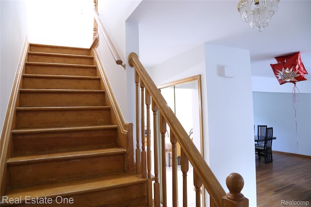 18675 Webster Ave, Southfield, MI 48076 - stairs featuring wood finished floors, a chandelier, and baseboards