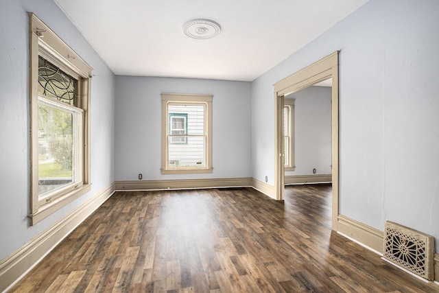 176 N Union St, Battle Creek, MI 49017 - spare room with healthy amount of natural light, wood finished floors, and baseboards