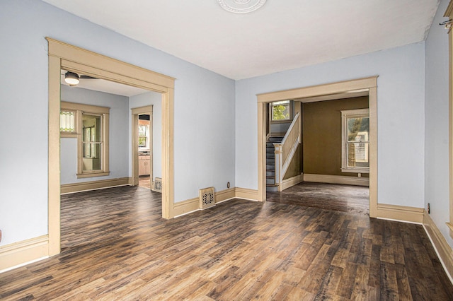 176 N Union St, Battle Creek, MI 49017 - empty room featuring wood finished floors, baseboards, and stairs
