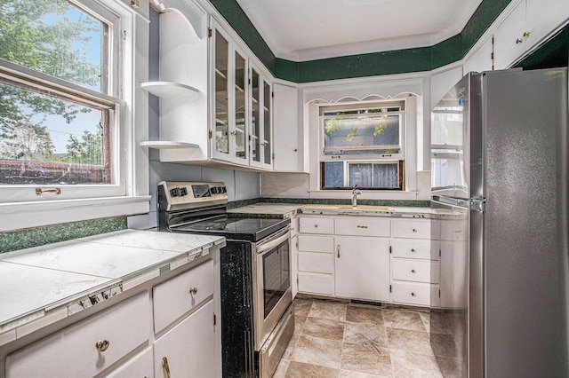 176 N Union St, Battle Creek, MI 49017 - kitchen featuring stainless steel appliances, plenty of natural light, and white cabinets