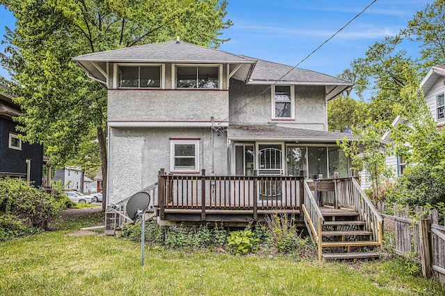 176 N Union St, Battle Creek, MI 49017 - back of house with stucco siding, roof with shingles, a deck, and a sunroom