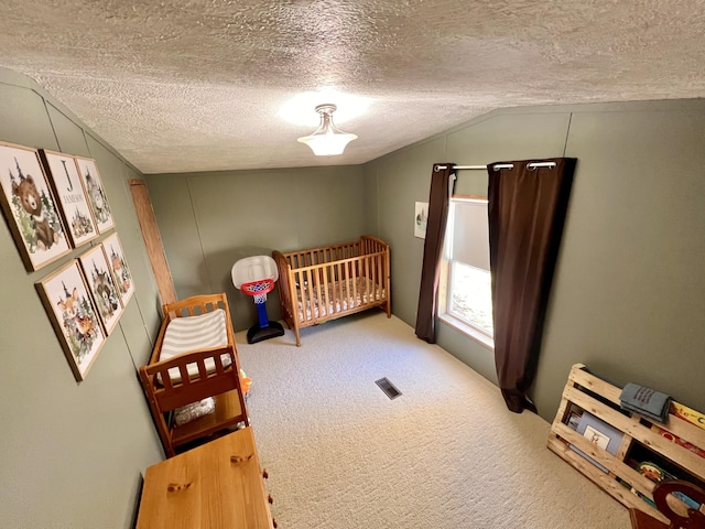 2828 Trepanier Dr Unit 515, Ludington, MI 49431 - carpeted bedroom with vaulted ceiling, a textured ceiling, and a crib
