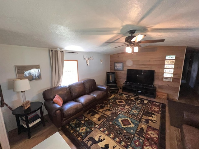 2828 Trepanier Dr Unit 515, Ludington, MI 49431 - living area featuring wood walls, wood finished floors, ceiling fan, and a textured ceiling
