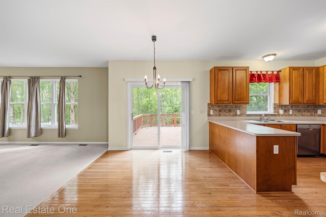 29329 Whistler Dr, Novi, MI 48377 - kitchen with dishwasher, a chandelier, light wood-type flooring, a sink, and a peninsula
