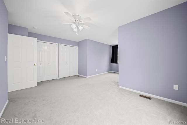 29329 Whistler Dr, Novi, MI 48377 - unfurnished bedroom featuring carpet, two closets, baseboards, and a ceiling fan