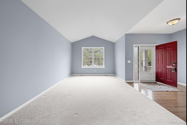 29329 Whistler Dr, Novi, MI 48377 - carpeted foyer featuring lofted ceiling, baseboards, and wood finished floors