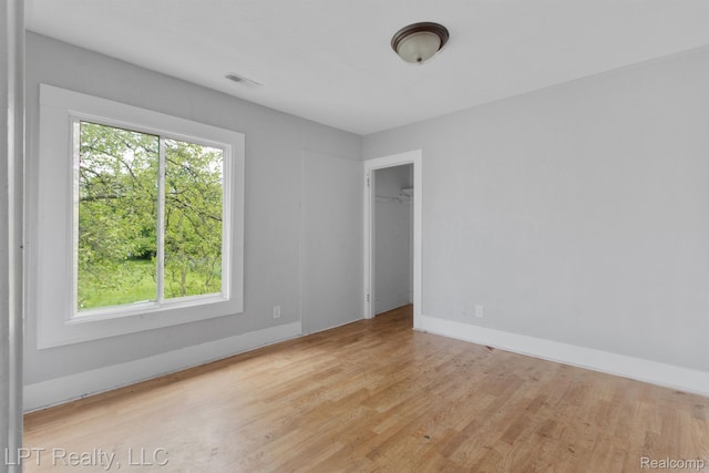 2174 Springle St, Detroit, MI 48215 - empty room featuring plenty of natural light, wood finished floors, and baseboards