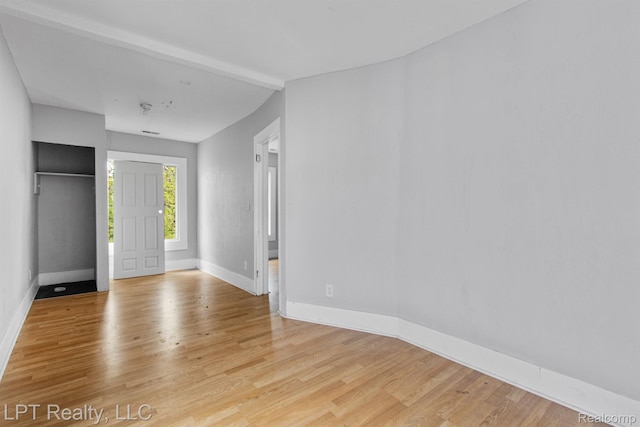 2174 Springle St, Detroit, MI 48215 - unfurnished bedroom featuring light wood-style flooring, baseboards, and vaulted ceiling