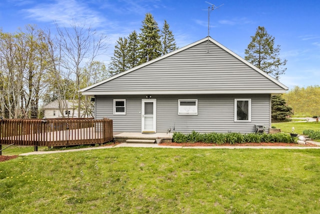 7256 Highland Dr, Beulah, MI 49617 - rear view of house with a deck and a yard