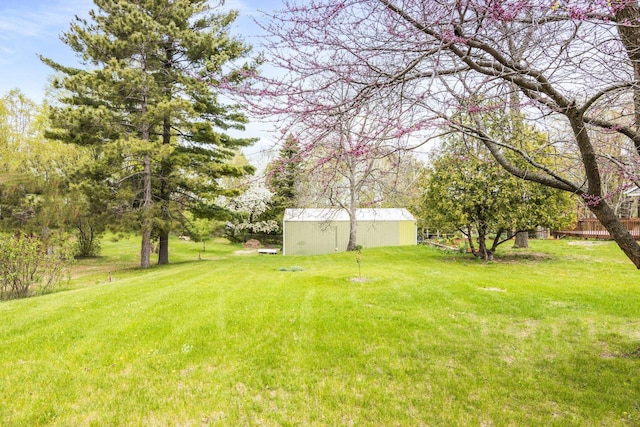 7256 Highland Dr, Beulah, MI 49617 - view of green lawn with an outbuilding and a pole building