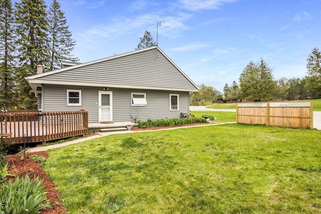 7256 Highland Dr, Beulah, MI 49617 - rear view of house with a yard, a deck, and a chimney