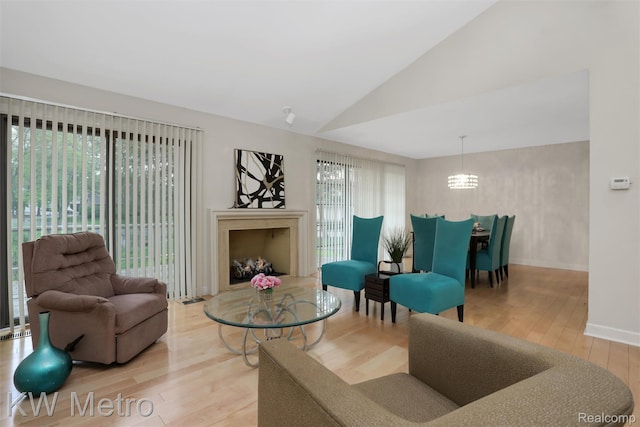 7273 Creeks Bend Ct, West Bloomfield, MI 48322 - living room with wood finished floors, a chandelier, lofted ceiling, baseboards, and a fireplace