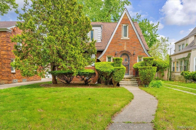 14004 Abington Ave, Detroit, MI 48227 - english style home featuring a front lawn and brick siding
