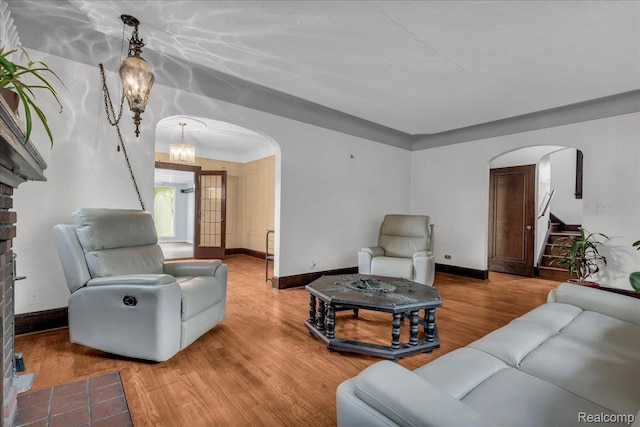 14004 Abington Ave, Detroit, MI 48227 - living room with arched walkways, wood finished floors, baseboards, and a chandelier