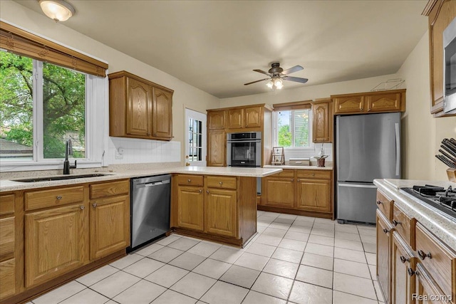14004 Abington Ave, Detroit, MI 48227 - kitchen with stainless steel appliances, a sink, light countertops, and a ceiling fan