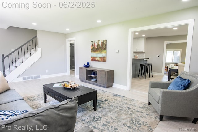 2750 Lansdowne Rd, Waterford, MI 48329 - living area featuring recessed lighting, light wood finished floors, stairway, and baseboards