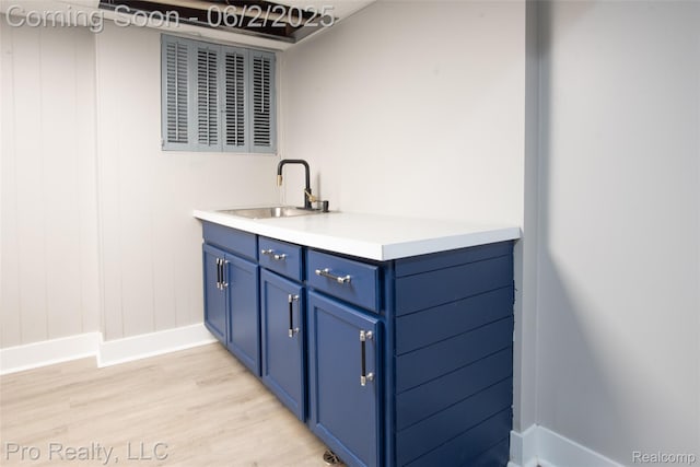 2750 Lansdowne Rd, Waterford, MI 48329 - bar area with a sink, baseboards, and light wood-style flooring
