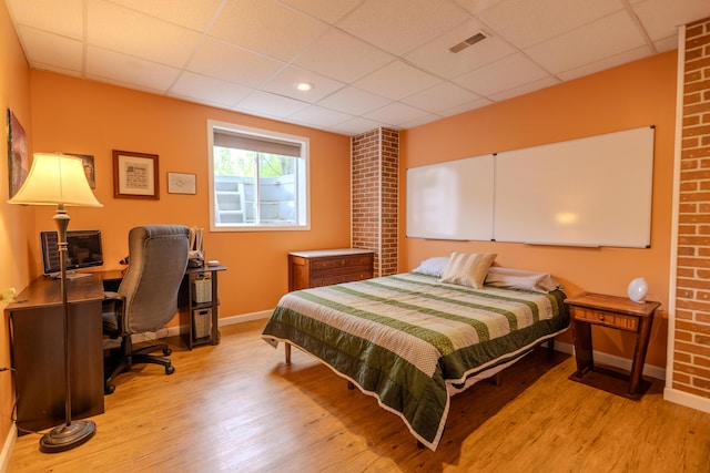 6573 Sweet Clover Hills Dr, Jonesville, MI 49250 - bedroom with a paneled ceiling, wood finished floors, baseboards, and a desk