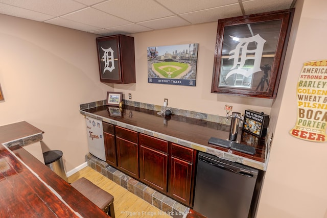 6573 Sweet Clover Hills Dr, Jonesville, MI 49250 - indoor dry bar with wood finished floors, stainless steel dishwasher, a paneled ceiling, and baseboards