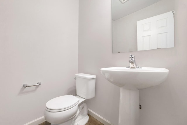 6129 Pollys Path, Berrien Springs, MI 49103 - bathroom with baseboards, toilet, and a sink