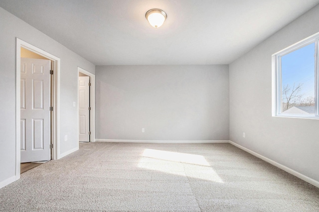 6129 Pollys Path, Berrien Springs, MI 49103 - unfurnished bedroom featuring carpet, multiple windows, and baseboards
