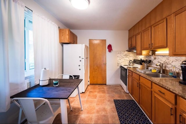 116/118 Glendale Dr, Ann Arbor, MI 48103 - kitchen featuring range with electric cooktop, freestanding refrigerator, a sink, and brown cabinets