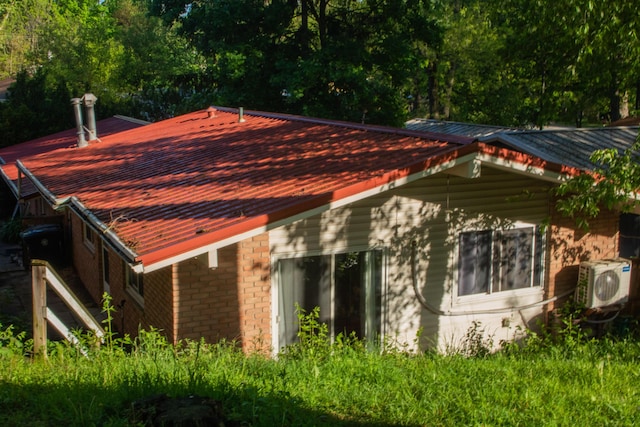 116/118 Glendale Dr, Ann Arbor, MI 48103 - view of side of property with brick siding, a cooling unit, and metal roof