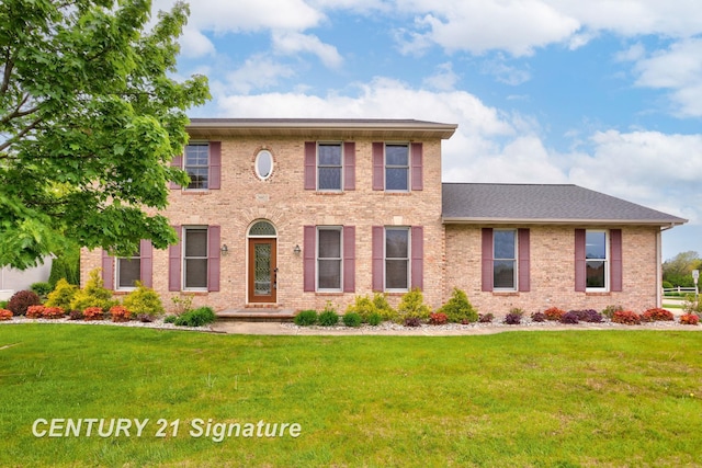 3803 Prairie Creek St, Saginaw, MI 48603 - colonial-style house featuring a front lawn and brick siding