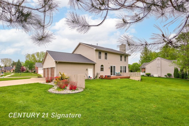 3803 Prairie Creek St, Saginaw, MI 48603 - back of property featuring a chimney, concrete driveway, a lawn, and a wooden deck