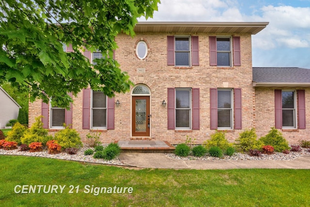 3803 Prairie Creek St, Saginaw, MI 48603 - colonial inspired home featuring a front lawn and brick siding