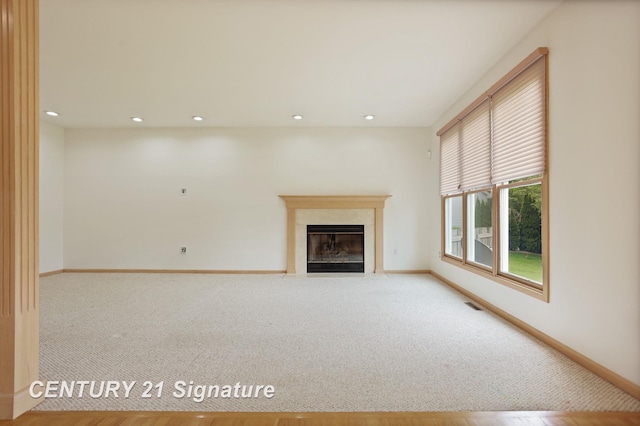 3803 Prairie Creek St, Saginaw, MI 48603 - unfurnished living room featuring baseboards, carpet flooring, a high end fireplace, and recessed lighting