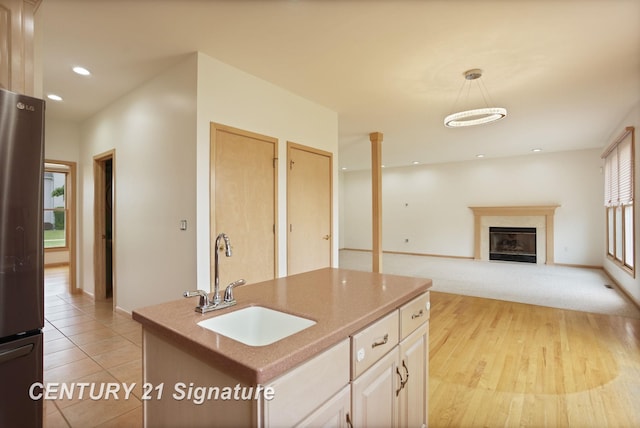 3803 Prairie Creek St, Saginaw, MI 48603 - kitchen featuring a sink, freestanding refrigerator, a fireplace, baseboards, and recessed lighting