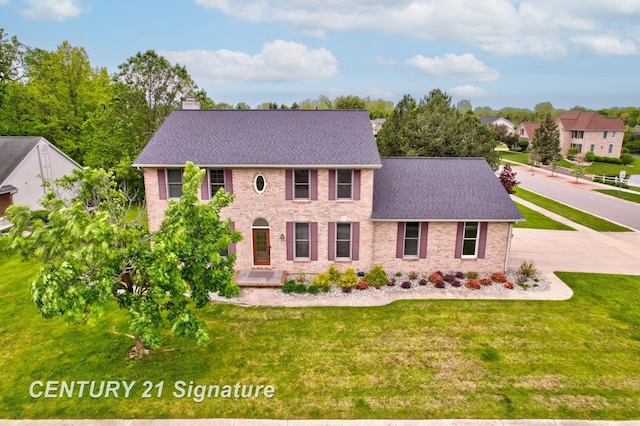 3803 Prairie Creek St, Saginaw, MI 48603 - colonial house with brick siding, a shingled roof, and a front yard