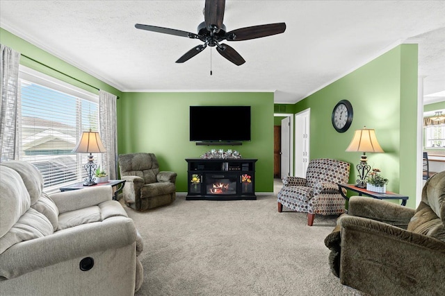 11855 Cedarbrook Dr, South Lyon, MI 48178 - living area with crown molding, carpet floors, a ceiling fan, a glass covered fireplace, and baseboards