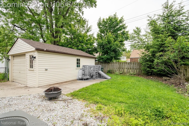 1395 Aline Dr, Grosse Pointe Woods, MI 48236 - view of yard featuring a fire pit, an outdoor structure, a patio area, and a detached garage