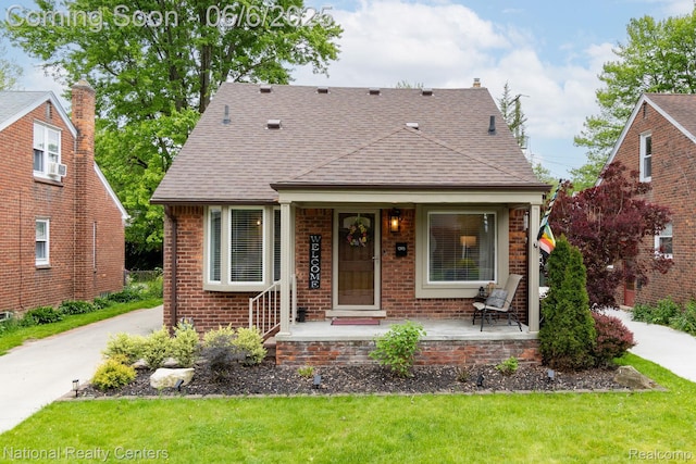 1395 Aline Dr, Grosse Pointe Woods, MI 48236 - bungalow with brick siding, a shingled roof, a front yard, and covered porch